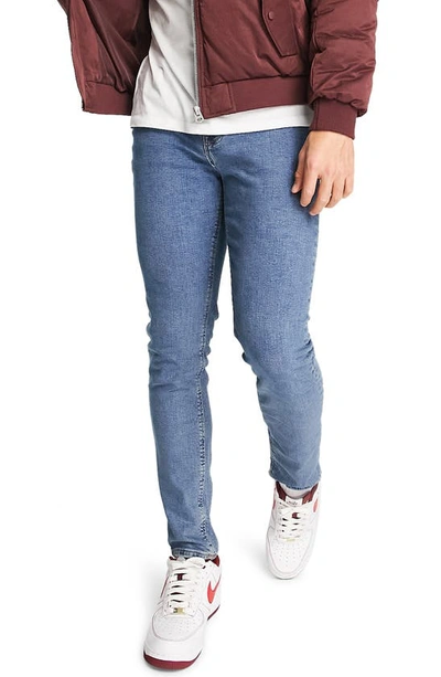 Asos Design Skinny Fit Stretch Jeans In Medium Blue