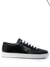 Prada Gold Logo Leather Low-top Sneakers In Black White