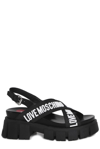 LOVE MOSCHINO LOVE MOSCHINO LOGO DETAILED CROSSOVER STRAP SANDALS