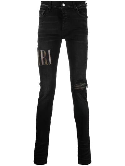 Amiri Logo-print Distressed Jeans In Black