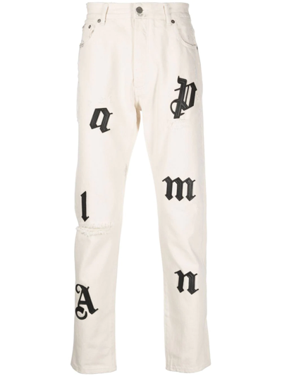 Palm Angels Distressed Logo-patch Straight Leg Jeans In Beige