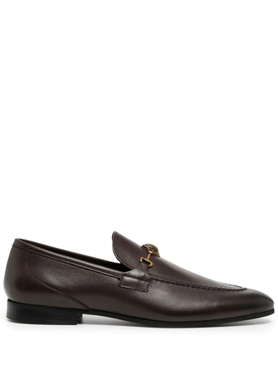 Kurt Geiger Ali Eagle Head Embellished Leather Loafers In Brown