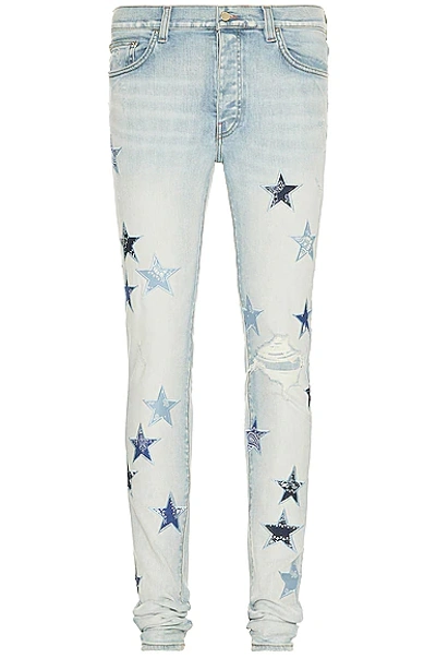 Amiri Bandana Star-appliqué Slim-fit Tapered Stretch-denim Jeans In Light Indigo