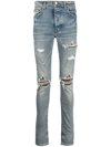 Amiri Mx1 Skinny-fit Leather-panelled Distressed Jeans In Denim