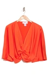 Renee C Plunge Neck Long Sleeve Twisted Knot Satin Top In Orange