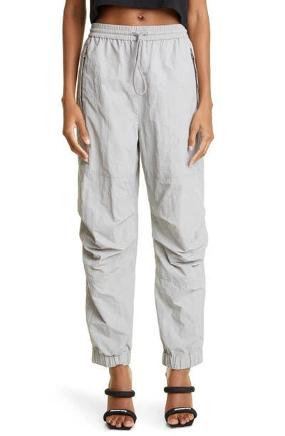 Alexander Wang Logo-flocked Tapered Shell Jogging Bottoms In Alloy