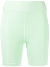 The Upside Solstice Mid Rise Spin Shorts In Green