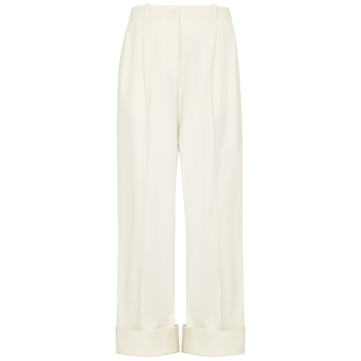 The Row Cassandro Pleated Stretch-wool Tapered Pants In Cream