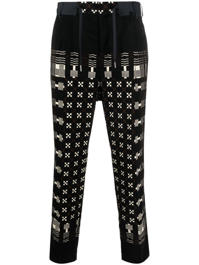 Sacai Graphic-print Tapered-leg Trousers In Black