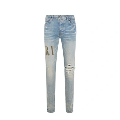 Amiri Logo-embroidered Ripped-detail Jeans In Blue