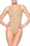 Skims Beige Seamless Sculpt Deep Plunge Thong Bodysuit In Clay