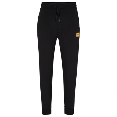 Hugo Boss Cotton-terry Tracksuit Bottoms With Foil-print Logo In Black