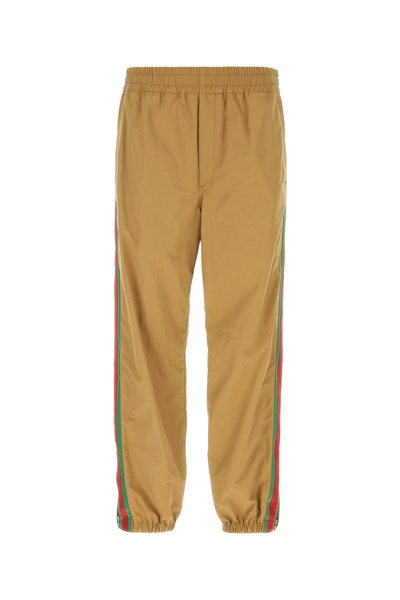 Gucci Logo Embroidered Tapered Pants In Beige