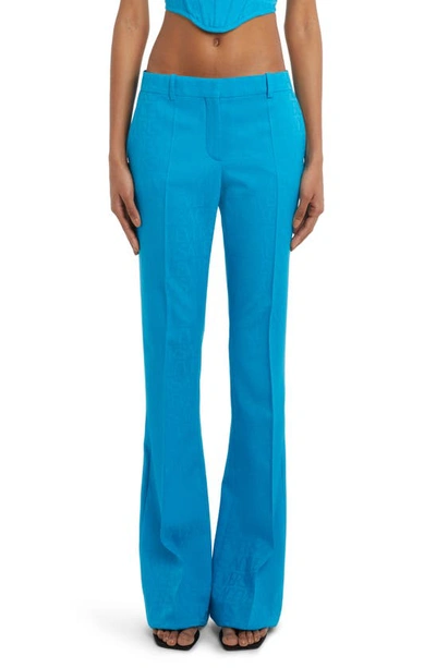 Versace Allover Logo Flared Trousers In Blue