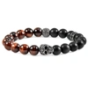 Crucible Jewelry Crucible Los Angeles Single Gold Skull Stretch Bracelet With 10mm Matte Black Onyx And Red Tiger Eye In Black