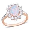 MIMI & MAX 2 1/6 CT TGW OVAL SHAPE BLUE ETHIOPIAN OPAL AND WHITE TOPAZ AND 1/10 CT TW DIAMOND HALO RING IN ROSE