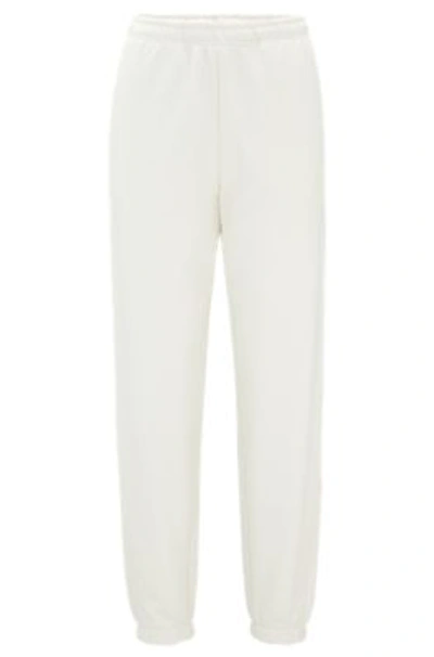 Hugo Relaxed-fit Tracksuit Bottoms With Embossed Stacked Logo In White