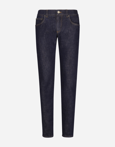 DOLCE & GABBANA SKINNY STRETCH DENIM JEANS WITH FLOCKED LOGO TAG