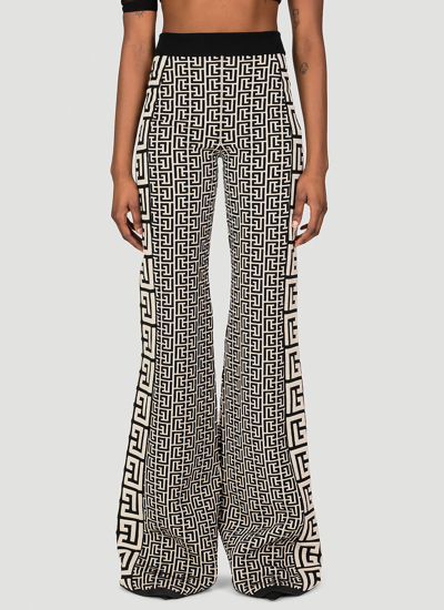 Balmain Monogram-print Flared Trousers In Black