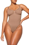 Skims Deep Plunge Strapless Thong Shapewear Bodysuit Thong Clay In Sienna