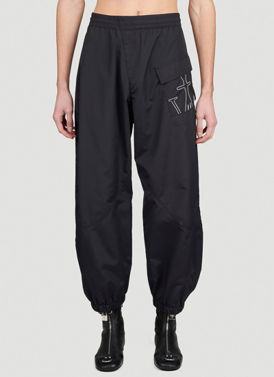 JW ANDERSON ANCHOR LOGO EMBROIDERED TWISTED TRACK PANTS