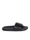 TOM FORD TOM FORD ELEVATES THE CLASSIC SLIDES WITH A REFINED TOUCH. THEYÂRE CRAFTED FROM BLACK LEATHER AND 
