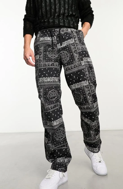 Asos Design Wide Cargo Parachute Pants In Black Paisley Print