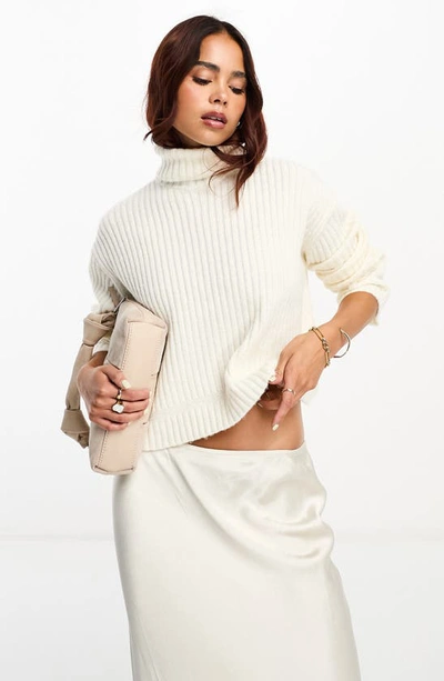 Asos Design Boxy Sweater In Rib With Roll Neck In Cream-white