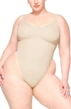 Skims Seamless Sculpt Scoop Neck Thong Bodysuit In Sand