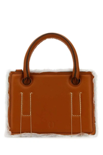 Dentro Handbags. In Brown