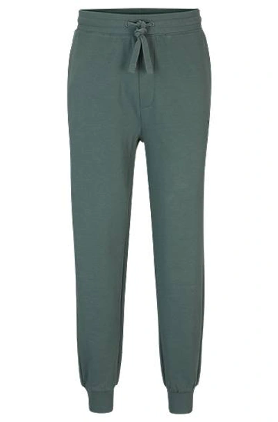 Hugo Boss Cotton-terry Tracksuit Bottoms With Logo Print In Green