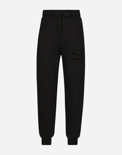 Dolce & Gabbana Jogging Pants With Rhinestone-detailed Dg Patch In Black