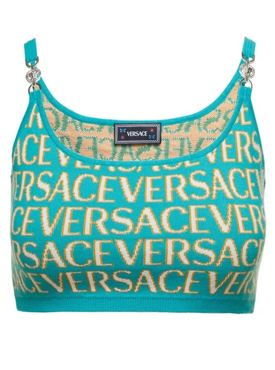 VERSACE LIGHT BLUE CROP TOP WITH ALL-OVER LOGO LETTERING AND MEDUSA DETAIL IN COTTON BLEND