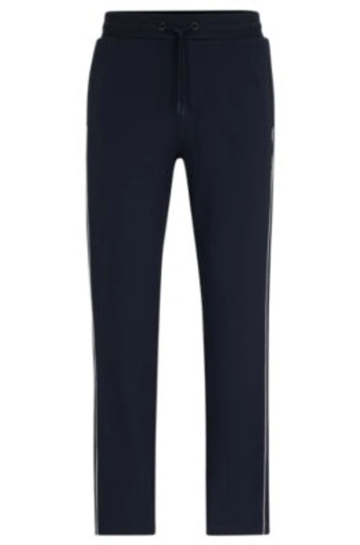 Hugo Boss Regular-fit Tracksuit Bottoms With Contrast Piping In Dark Blue