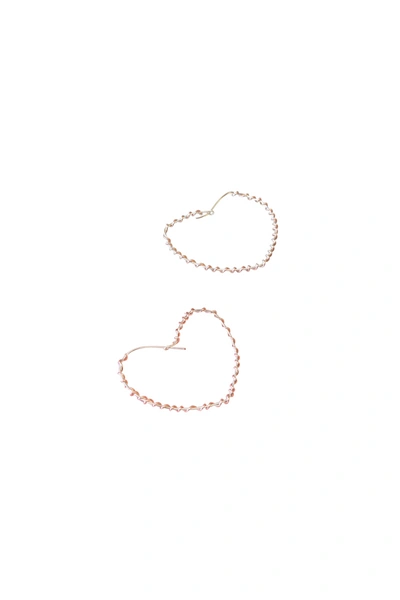 A Blonde And Her Bag Wrapped Around The Heart Earring In Silver With Rose Gold Wrap