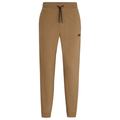 Hugo Monogram-print Tracksuit Bottoms With Striped Tape In Light Brown