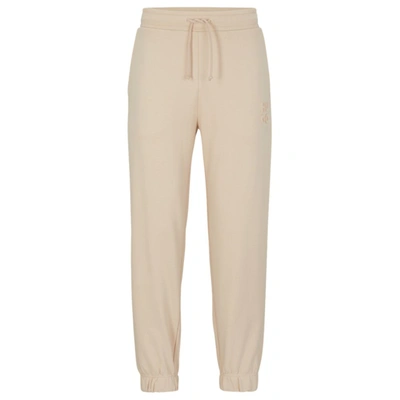 Hugo Boss Relaxed-fit Cotton-terry Tracksuit Bottoms With Stacked Logo In Beige