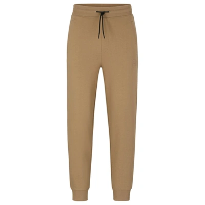 Hugo Cuffed Tracksuit Bottoms In French Terry With Logo Badge In Light Brown