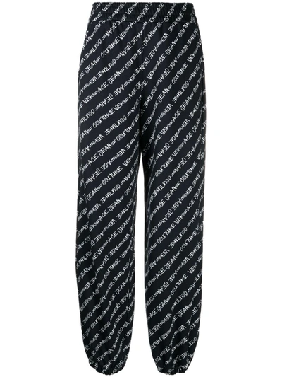Versace Jeans Couture Allover Logo Printed Track Pants In Black