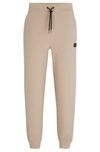 Hugo Stretch-cotton Tracksuit Bottoms With Stacked Logo In Beige