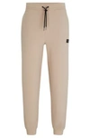 Hugo Boss Stretch-cotton Tracksuit Bottoms With Stacked Logo In Beige
