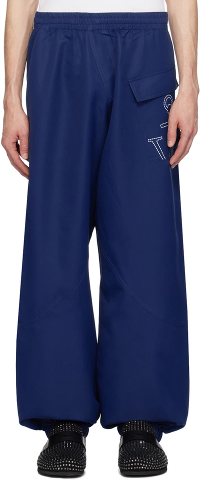 Jw Anderson Twisted Joggers With Anchor Logo Print In Blue