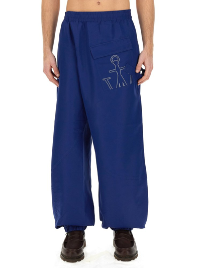 Jw Anderson Twisted Joggers With Anchor Logo Print In Blue