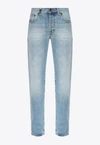 SAINT LAURENT DISTRESSED TAPERED JEANS
