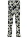 PALM ANGELS BLACK AND WHITE PANTS WITH ALL-OVER PALM PRINT IN TECH FABRIC MAN