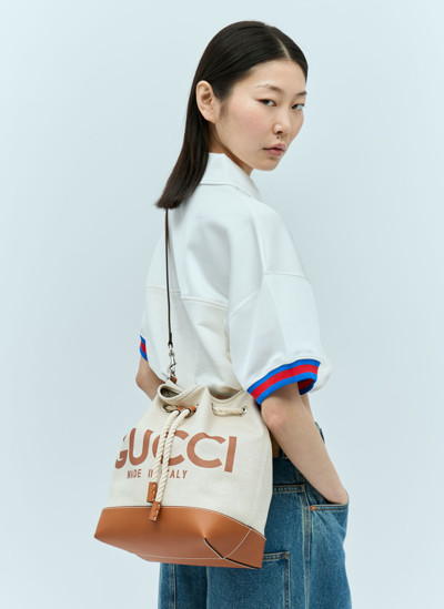 Gucci Logo Print Drawstring Shoulder Bag In Beige | ModeSens
