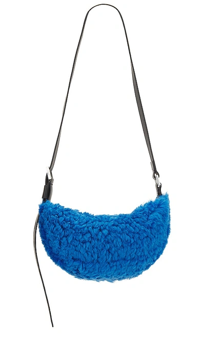Allsaints Half Moon Shearling Xbody Bag In Sully Blue
