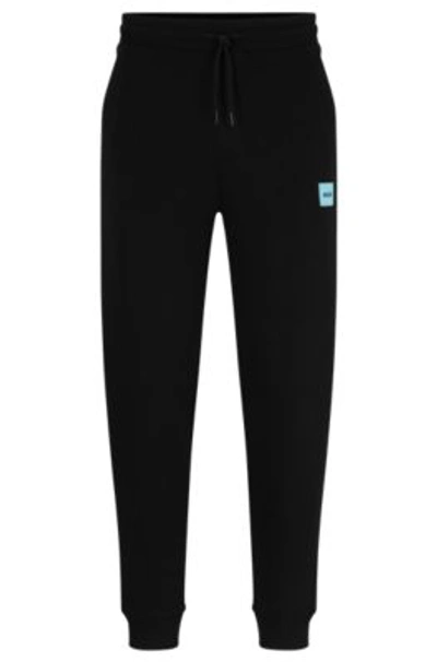 Hugo Cotton-terry Tracksuit Bottoms With Red Logo Label In Black