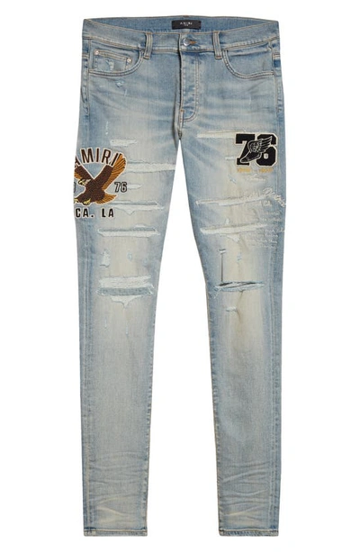 AMIRI VARSITY EAGLE LOGO RIPPED SKINNY JEANS