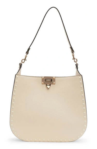 Valentino Garavani Small Rockstud Leather Hobo Bag In 098 Ivory